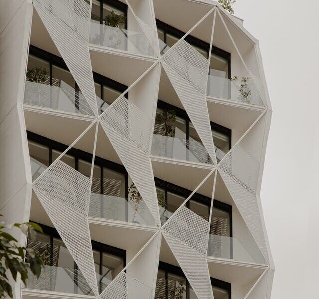 Casa Roma 350, edificio de departamentos en la Roma Norte con fachada triangular blanca, por Brag Arquitectos